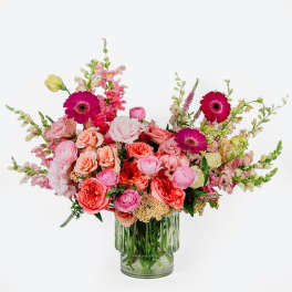 Pink and coral mixed bouquet in a clear glass vase