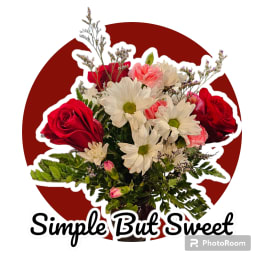 Bouquet of red roses, white daisies, and pink carnations