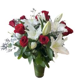 Red roses and white lilies arranged in a green vase