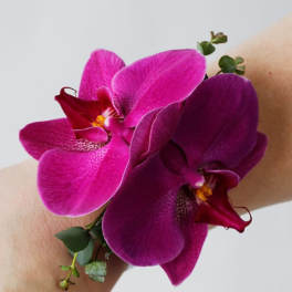 Purple orchid corsage on a wrist