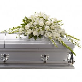 White floral spray on a silver casket
