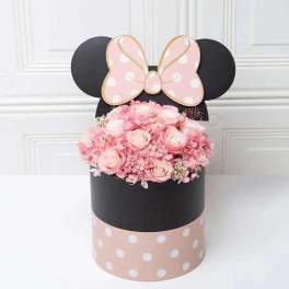 Pink rose arrangement in a black polka-dot box with a Minnie Mouse bow topper