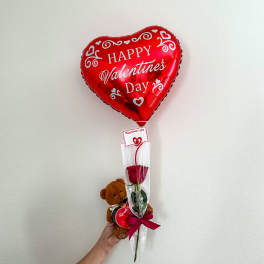 Red heart-shaped Valentine balloon with a rose and teddy bear