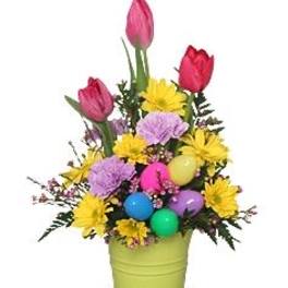 Colorful bouquet in a green bucket with tulips and daisies