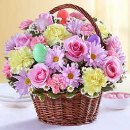 Basket of pink and yellow flowers with a pastel egg