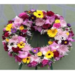 Colorful floral wreath with pink, yellow, purple, and white flowers