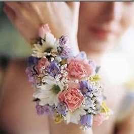 Small pastel floral wrist corsage with pink and purple blooms