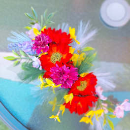 Colorful flower crown with red, pink, yellow, and lavender blooms