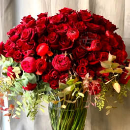 Large bouquet of red roses in a clear glass vase
