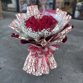 Bouquet of red roses with baby's breath and a decorative ribbon