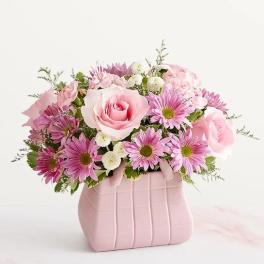 Pink rose and daisy bouquet in a pale pink vase