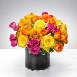 Bouquet of yellow, orange, and pink roses in a black vase