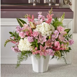 Pink and white floral arrangement in a white vase