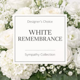 White floral sympathy arrangement with roses and hydrangeas