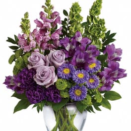Purple and lavender bouquet in a clear glass vase