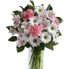 Pink carnations and white daisies in a clear glass vase