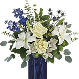 White lilies and roses in a blue glass vase