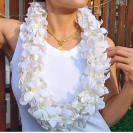 White orchid lei worn over a white tank top