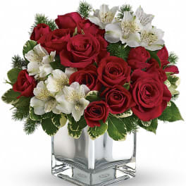Red roses and white alstroemeria in a clear square vase