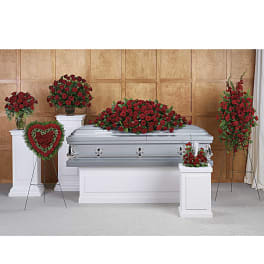 Red rose funeral casket spray with matching standing arrangements