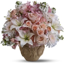 Pink and white floral arrangement in an ornate vase