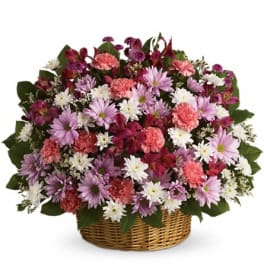 Basket arrangement of pink, purple, and white flowers