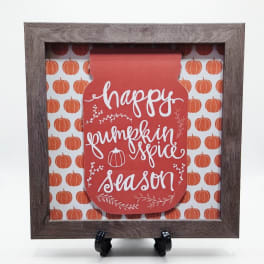 Framed fall sign reading "happy pumpkin spice season" with pumpkin pattern