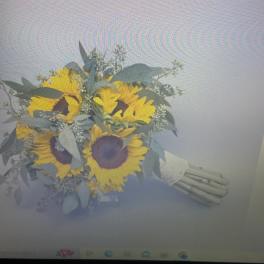Bouquet of yellow sunflowers with pale greenery and white filler