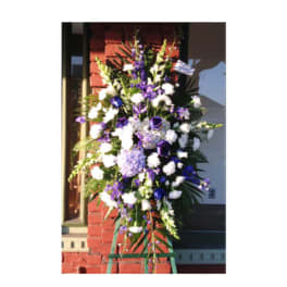 Tall standing floral spray with white and purple flowers on an easel