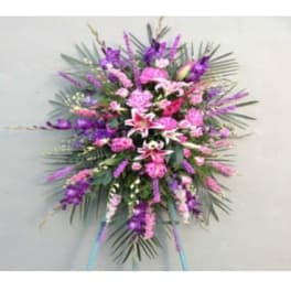 Large pink and purple standing floral spray with lilies and carnations