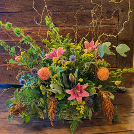 Large mixed floral arrangement with pink lilies and peach dahlias