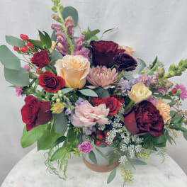 Mixed bouquet of roses and pink blooms in a vase