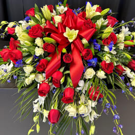Large red and white floral spray with a red ribbon bow
