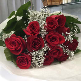 Bouquet of red roses with baby's breath wrapped in white paper