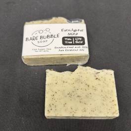 Two bars of eucalyptus mint soap, one wrapped and one unwrapped