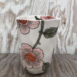 White ceramic pot with pink floral pattern