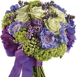 Bouquet of purple and pale green flowers tied with a purple ribbon