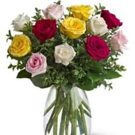 Bouquet of multicolored roses in a clear glass vase