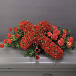 Red floral casket spray with tulips and roses