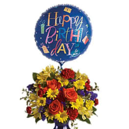 Birthday balloon above a colorful flower arrangement in a blue vase