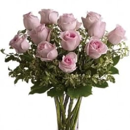 Bouquet of pale pink roses in a clear glass vase