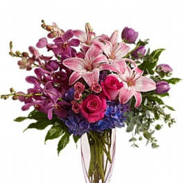 Pink lilies and roses in a clear glass vase
