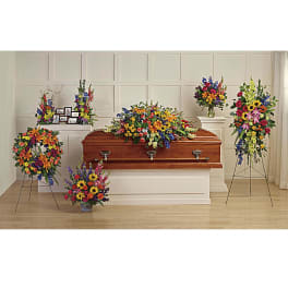 Casket surrounded by colorful funeral flower arrangements