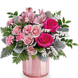 Pink roses and carnations in a pink glass vase