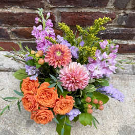 Bouquet of orange roses, pink dahlias, and lavender flowers