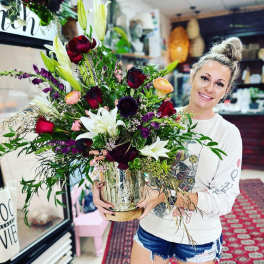 Large mixed bouquet in a glass vase with lilies and roses
