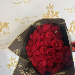 Bouquet of red roses wrapped in black and gold paper