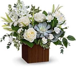 White roses and succulents in a wooden cube vase
