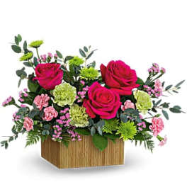 Pink roses and carnations in a wooden box arrangement