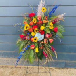 Tall colorful floral standing spray on a metal easel